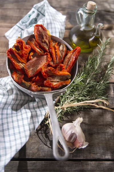 Dried tomatoes with rosemary — Stock Photo, Image