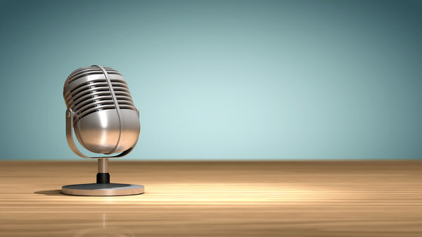 Vintage microphone placed on a wooden table and oriented to record