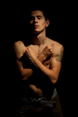 A man with nude torso and arms crossed on his chest