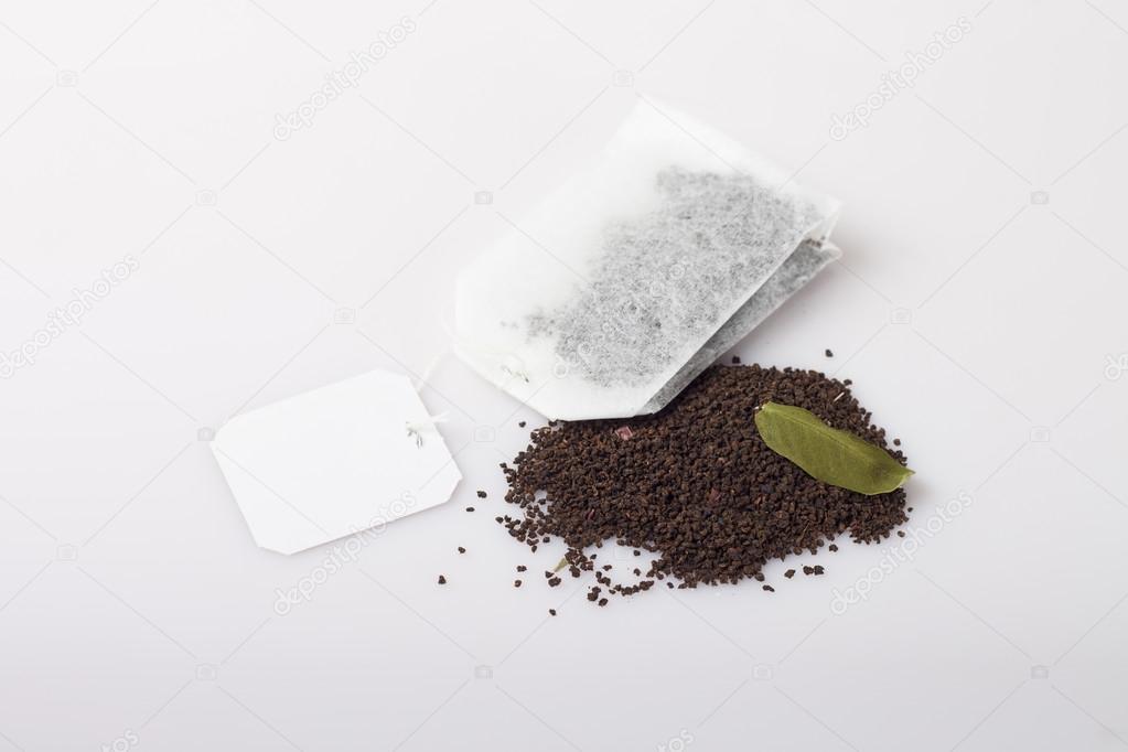 tea bag over dried leafs leaves background