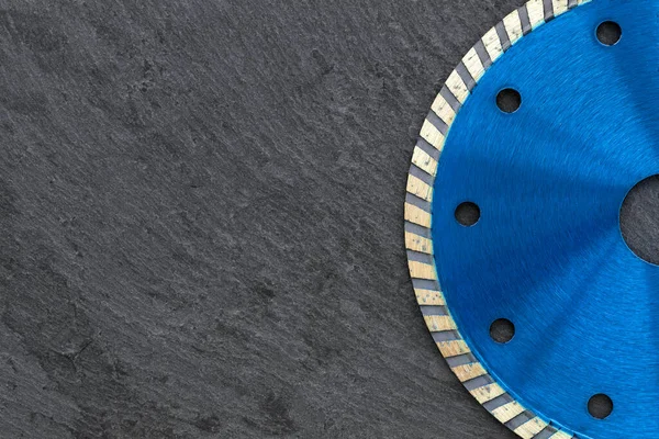 Part of a blue diamond cutting wheel for cutting and processing stone, concrete and reinforced concrete. Copy space, close-up.