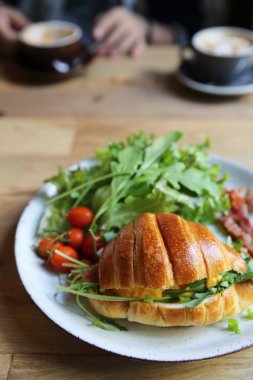 yumurta ve pastırma tahta arka plan ile kruvasan