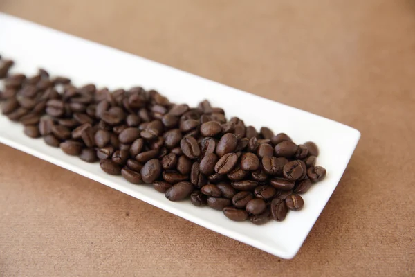 Coffee beans isolated in wood background — Stock Photo, Image