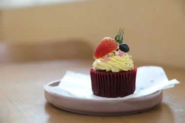 Ahşap masa arkasında renkli kekler