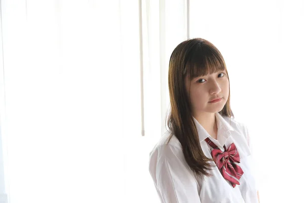 Portrait japanese school girl uniform in white tone bed room