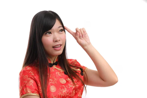 美少女は中国の旧正月に赤いチョンサムの思考と笑顔を身につけ — ストック写真
