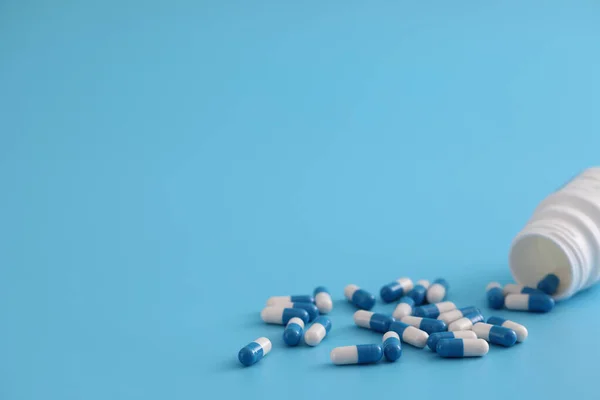 Pastillas Cápsulas Con Botella Aislada Sobre Fondo Azul —  Fotos de Stock