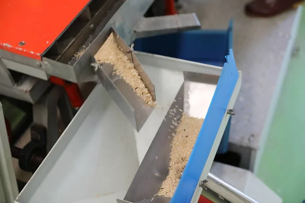 Factory machine Milling rice in close up