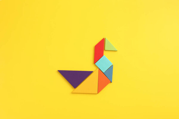 Wooden blocks duck isolated in yellow background