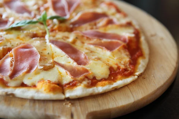 Пицца с сухой ветчиной и базиликом — стоковое фото