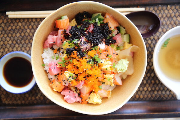 Sushi don , raw salmon tuna octopus on rice