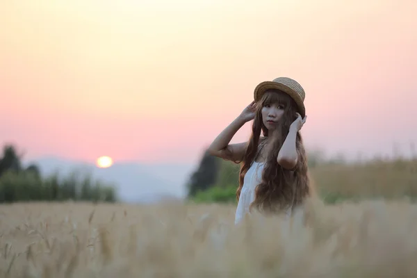 Asian girl on wheat — Stock Photo, Image