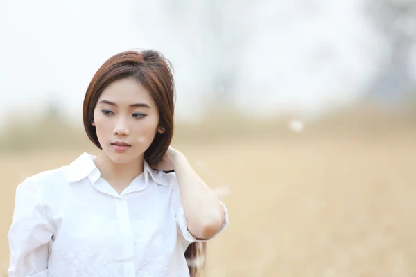 Asian girl on wheat field — Stock Photo, Image