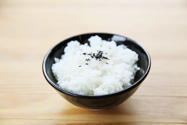 Arroz com fundo de madeira — Fotografia de Stock