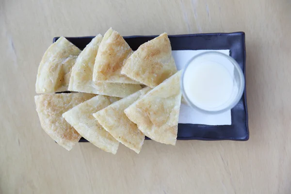 Roti with milk on wood background — Stock Photo, Image