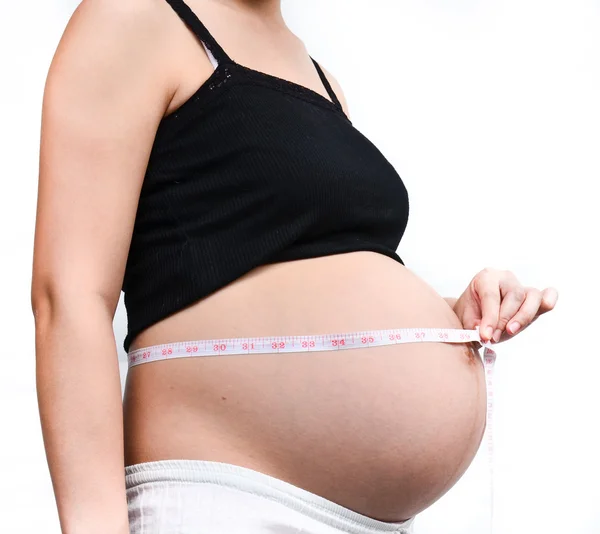 Woman holding her pregnant — Stock Photo, Image