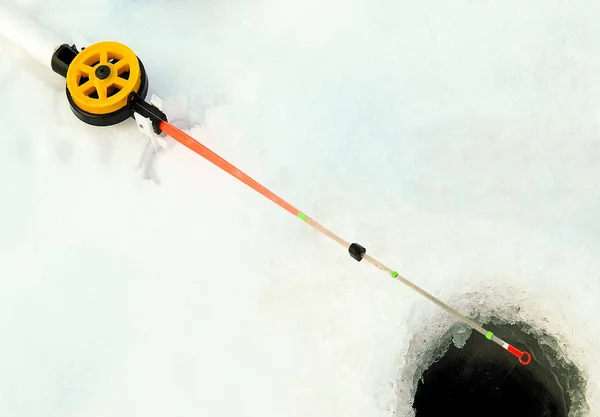 stock image Winter fishing.Fishing rod for winter fishing on the background of snow and ice.