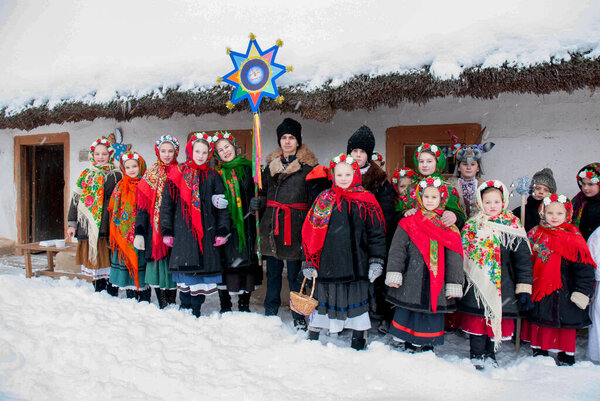  Christmas celebration. According to Ukrainian folk traditions, village children in Ukrainian costumes sing carols, invoking happiness in New Year in every home KIEV, UKRAINE