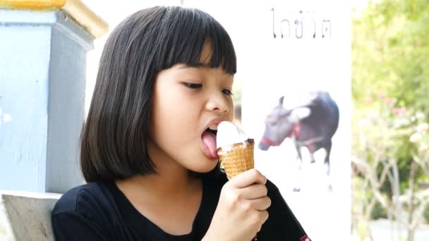 Asian kid licking ice cream. — Stock Video