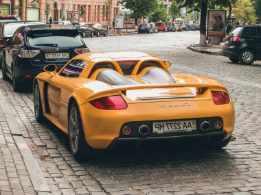 Kiev, Ukrayna - 12 Haziran 2011: Seçkin süper araba Porsche Carrera GT şehirde park halinde. Sarı Porsche