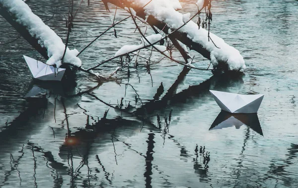 Paper boat in the water. Paper product. Background. Wallpaper. Reflection in water