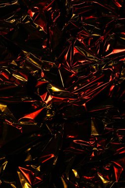 Folyo arka plan. Buruşuk folyo. Soyut arkaplan. Duvar kağıdı. Kırmızı, turuncu ve siyah