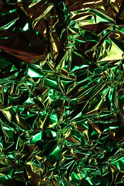 Foil background. Crumpled foil. Abstract background. Wallpaper. Green