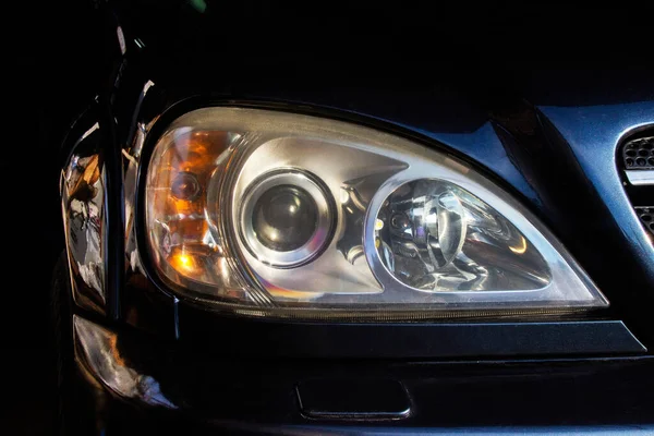 Car headlights. Luxury Headlights. Car details. Part of a blue car