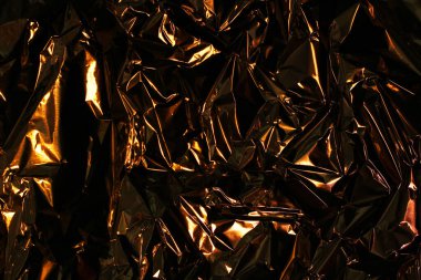 Folyo arka plan. Buruşuk folyo. Soyut arkaplan. Duvar kağıdı. Turuncu ve siyah