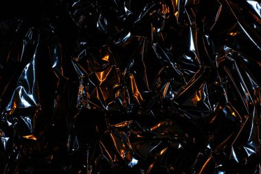 Folyo arka plan. Buruşuk folyo. Soyut arkaplan. Duvar kağıdı. Turuncu ve siyah