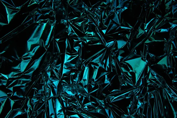 Foil background. Crumpled foil. Abstract background. Wallpaper. Blue