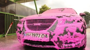 Chernigov, Ukrayna - 24 Temmuz 2021: Oto yıkamadaki Saab arabası. Pembe köpüklü gri Saab 9-5