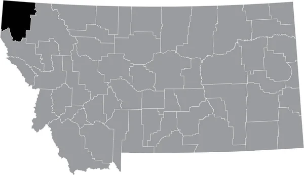 モンタナ州の灰色の地図の中のリンカーン郡の黒いハイライトされた場所 — ストックベクタ