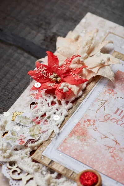 The handmade card, made with the technology of scrapbooking with cut and carved colourful elements