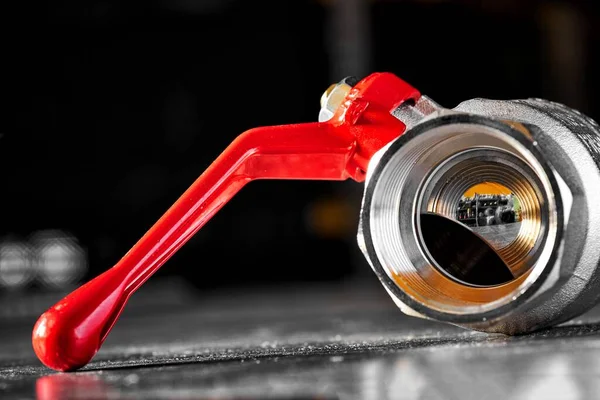 Stock image one plumbing water ball valve on a dark background is an indispensable important part of the pipeline.