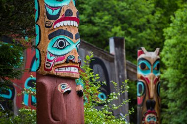 Totem Poles Near Saxman Tribal House  clipart