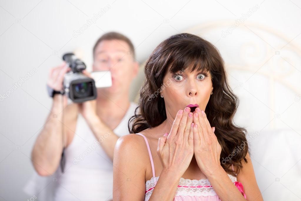 Couple with Video Camera in the Bedroom