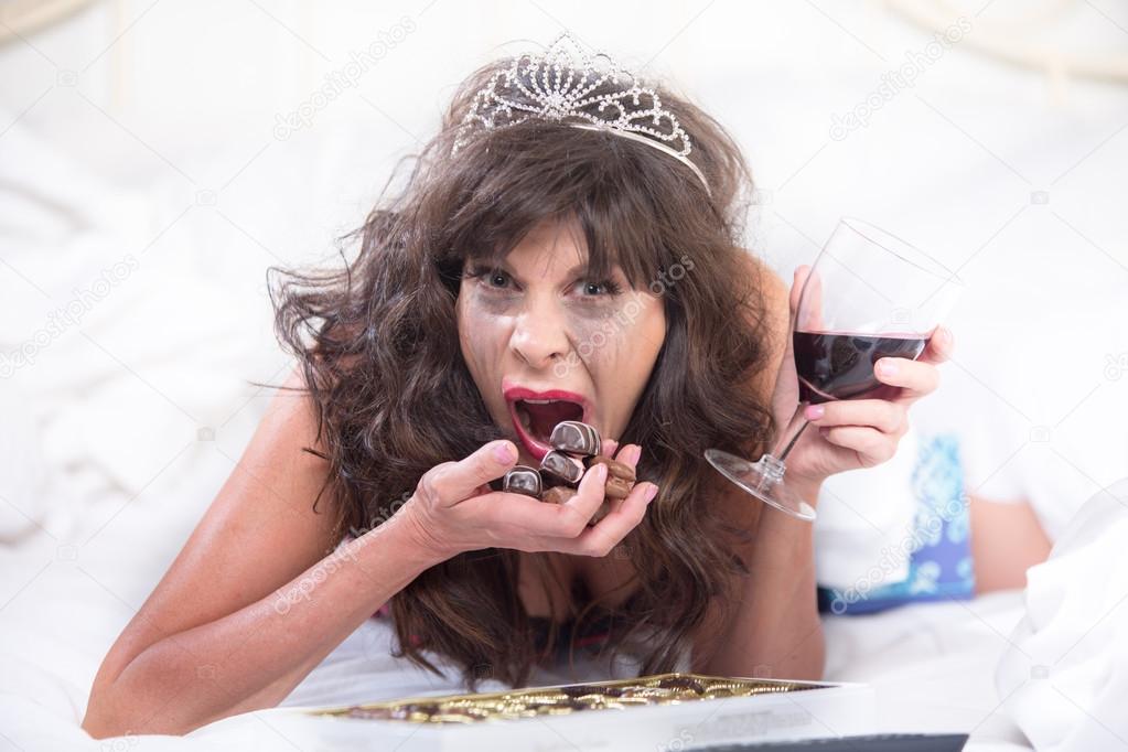 Upset Woman in Tiara Drinking Wine 