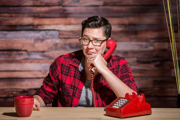 Frowning Woman on Red Phone — Stock Photo, Image