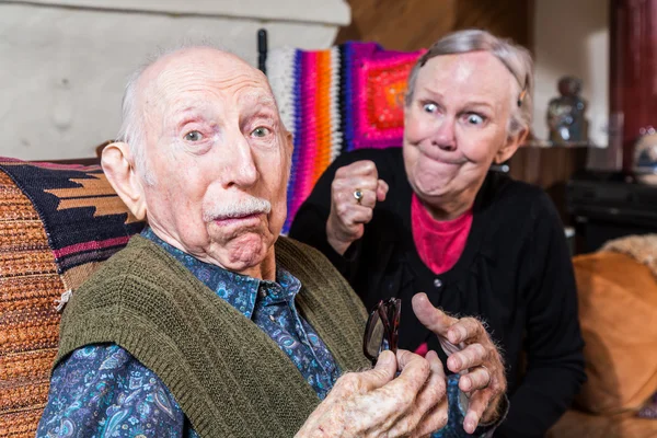 Arguing senior woman and confused husband — Stock Photo, Image