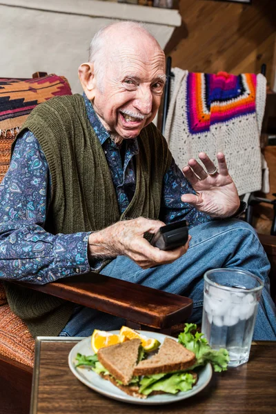Grumpy elderly man with sandwich — Stock Photo, Image