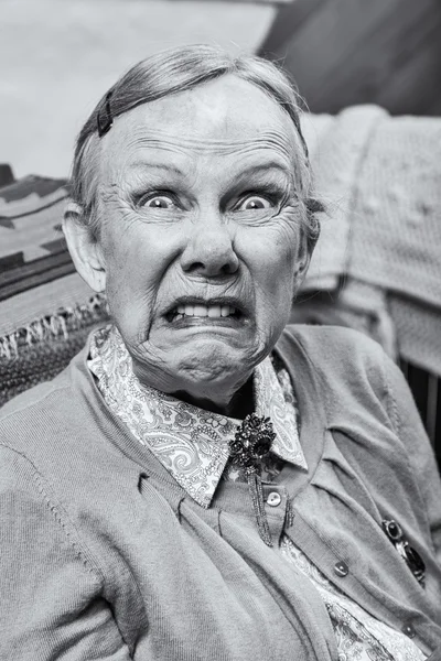 Elderly woman making a scary face — Stock Photo, Image