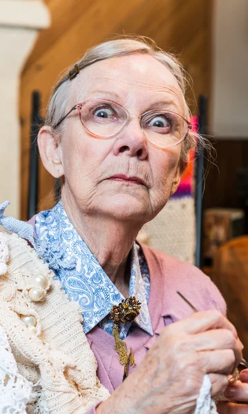 Old woman with crochet — Stock Photo, Image