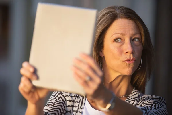 Woman Puckering Lips at digital Tablet — Stock Photo, Image