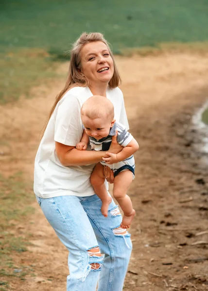 mother holding and kissing son