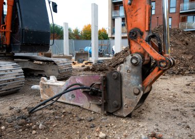 Yere yerleştirilmiş bir kazıcı kovasını güvenli bir şekilde kapatın.