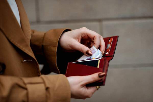 person holding card and money in their hands
