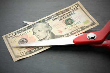 Red scissors cut money  clipart