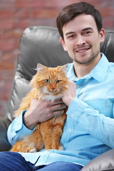 man with fluffy cat