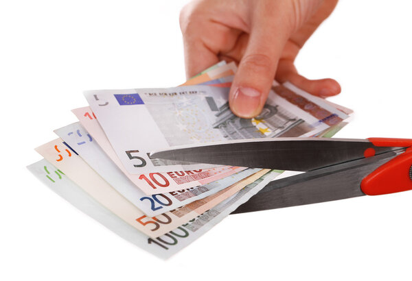 Hands with scissors cutting Euro